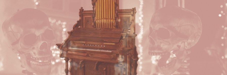 An ornate wooden organ with two grinning skeleton heads on either side of it.